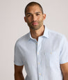 Model is wearing UNTUCKit Forbes performance seersucker short sleeve shirt in cerulean. 