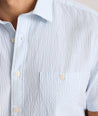 Model is wearing UNTUCKit Forbes performance seersucker short sleeve shirt in cerulean. 