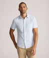 Model is wearing UNTUCKit Forbes performance seersucker short sleeve shirt in cerulean. 