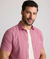 Model is wearing UNTUCKit Forbes performance seersucker short sleeve shirt in pink. 