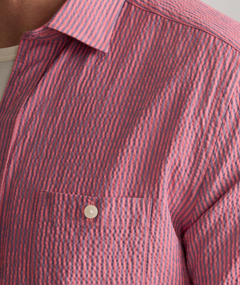 Model is wearing UNTUCKit Forbes performance seersucker short sleeve shirt in cerulean. 