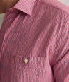 Model is wearing UNTUCKit Forbes performance seersucker short sleeve shirt in cerulean. 