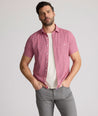 Model is wearing UNTUCKit Forbes performance seersucker short sleeve shirt in cerulean. 