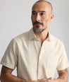 Model is wearing UNTUCKit Performance Seersucker Short-Sleeve Shirt in tan. 