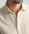 Model is wearing UNTUCKit Performance Seersucker Short-Sleeve Shirt in tan. 