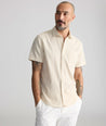 Model is wearing UNTUCKit Performance Seersucker Short-Sleeve Shirt in tan. 