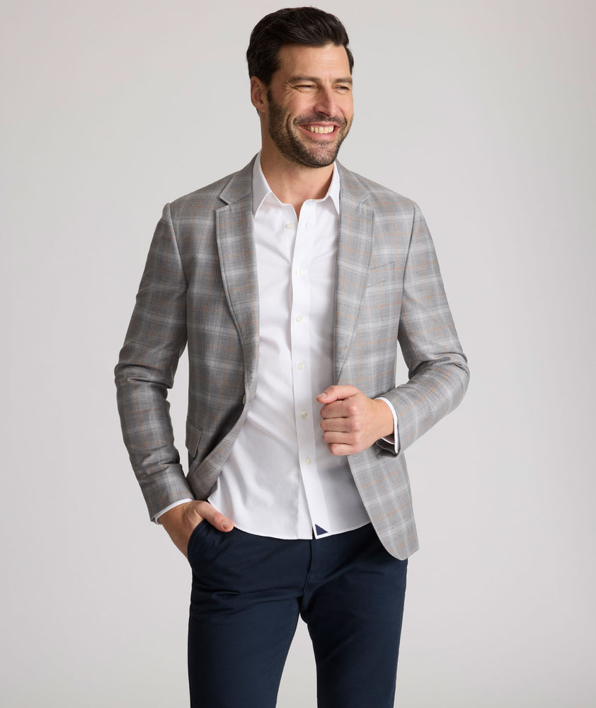 Model is wearing UNTUCKit France sport coat in gray. 