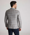 Model is wearing UNTUCKit France sport coat in gray. 