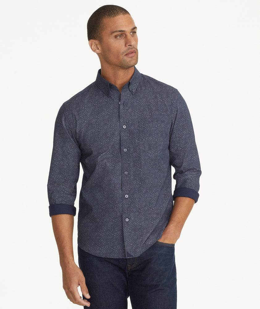 Model is wearing UNTUCKit Classic Cotton Fredonia Shirt in Navy Leaf Print.
