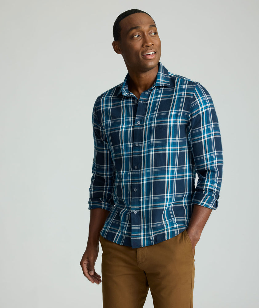 Model is wearing UNTUCKit Plaid Flannel Shirt in Navy & Light Blue Plaid | Fair Traide Certified™ . 