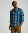 Model is wearing UNTUCKit Plaid Flannel Shirt in Navy & Light Blue Plaid | Fair Traide Certified™ . 