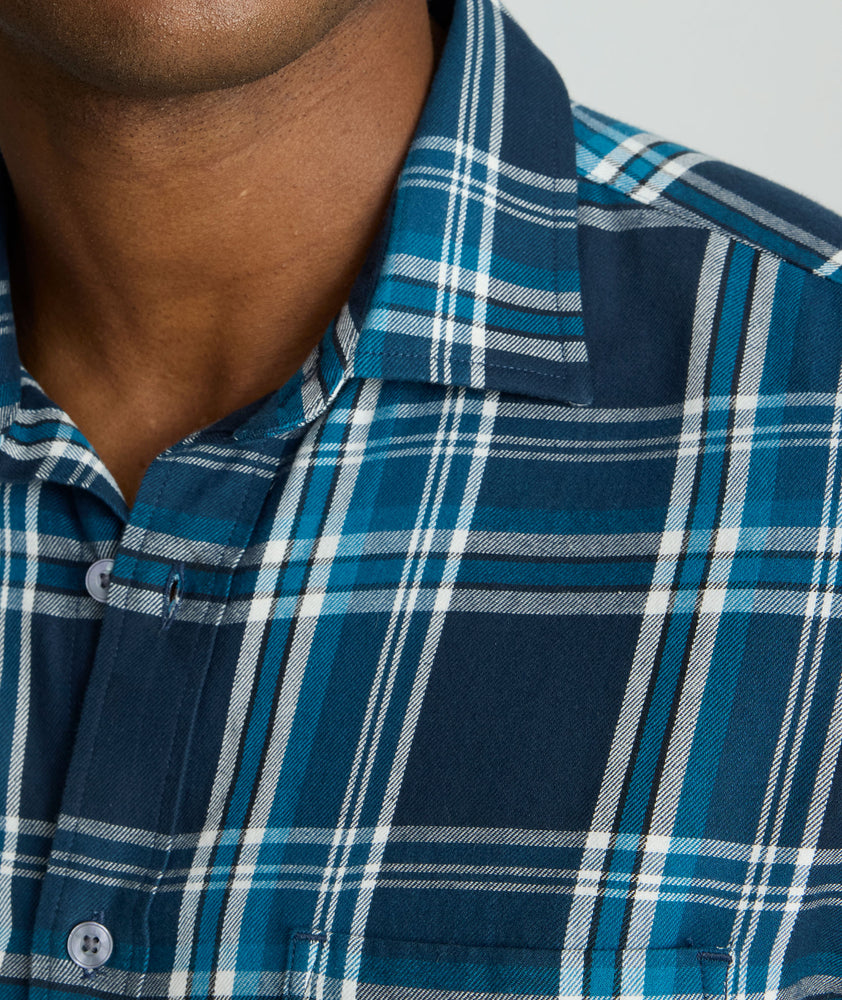 Model is wearing UNTUCKit Plaid Flannel Shirt in Navy & Light Blue Plaid | Fair Traide Certified™ . 