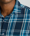 Model is wearing UNTUCKit Plaid Flannel Shirt in Navy & Light Blue Plaid | Fair Traide Certified™ . 
