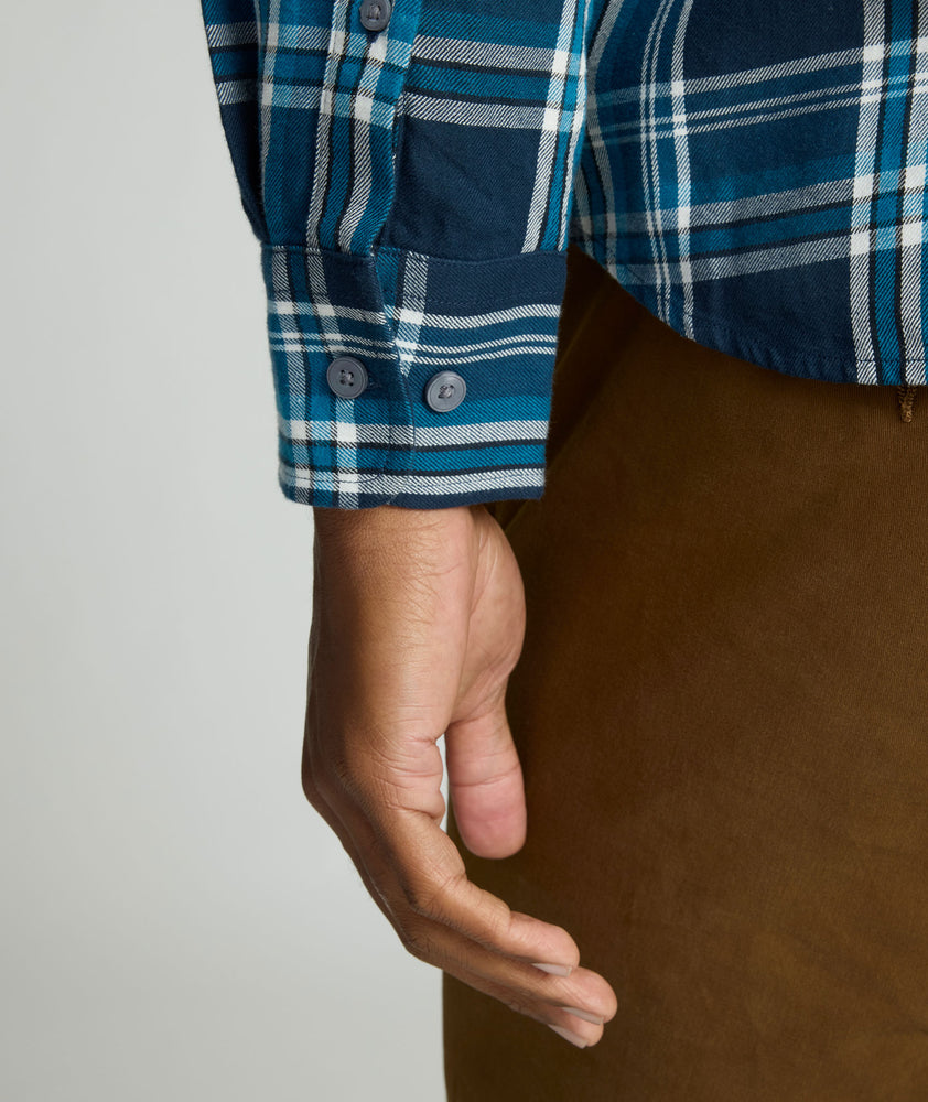 Model is wearing UNTUCKit Plaid Flannel Shirt in Navy & Light Blue Plaid | Fair Traide Certified™ . 
