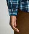 Model is wearing UNTUCKit Plaid Flannel Shirt in Navy & Light Blue Plaid | Fair Traide Certified™ . 