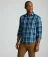 Model is wearing UNTUCKit Plaid Flannel Shirt in Navy & Light Blue Plaid | Fair Traide Certified™ . 