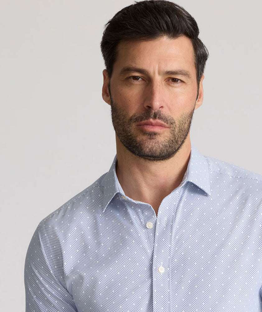 Model is wearing UNTUCKit Fuller performance shirt in dot print. 