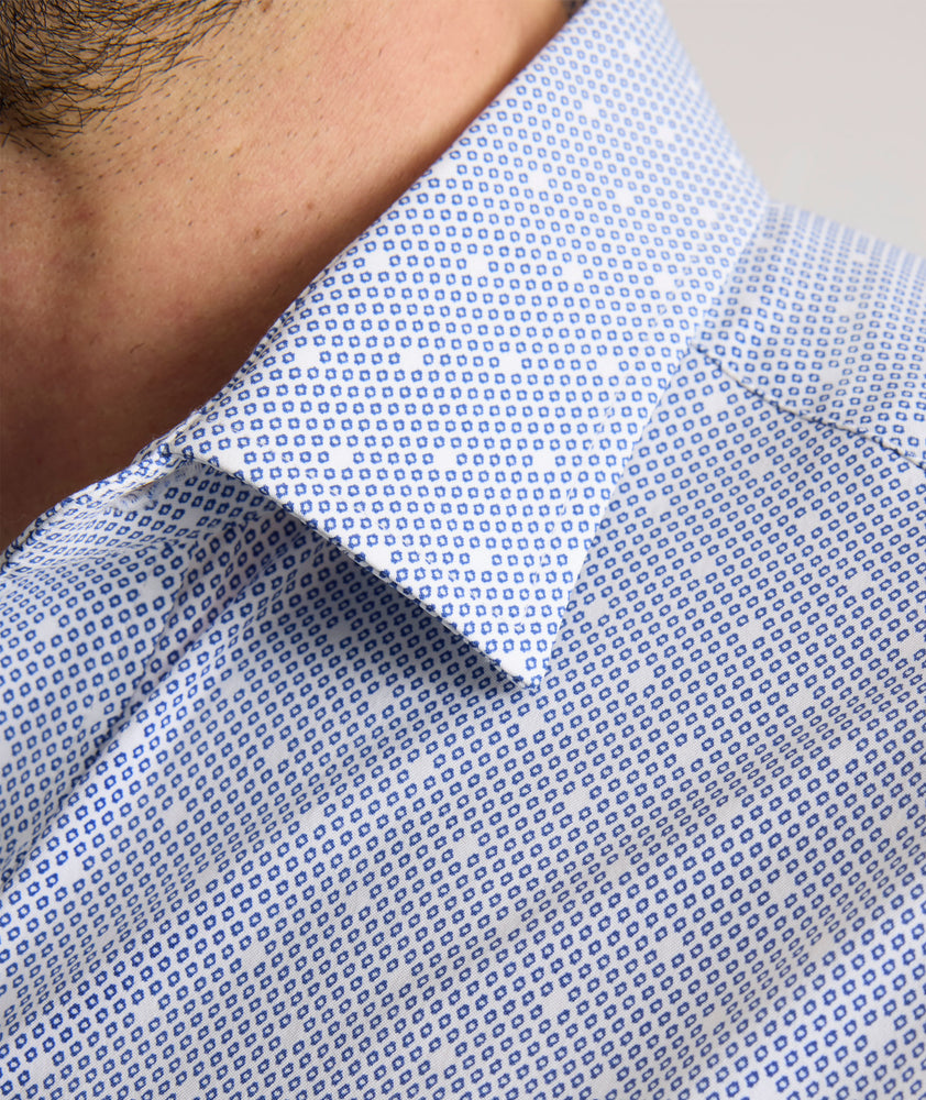 Model is wearing UNTUCKit Fuller performance shirt in dot print. 