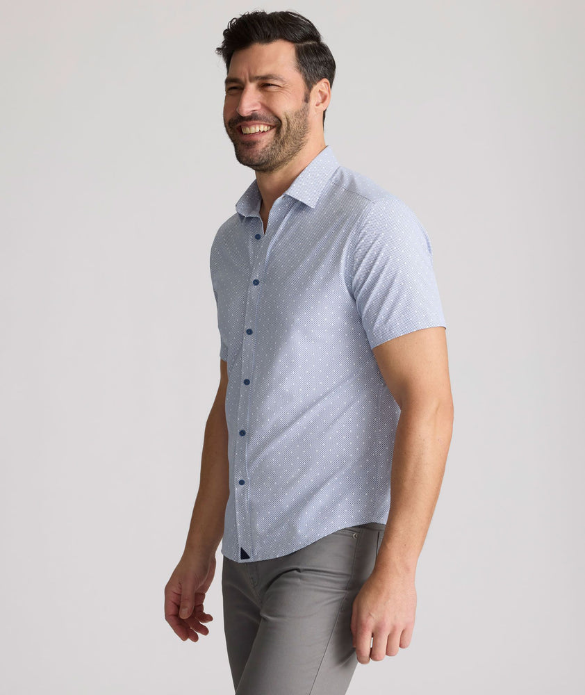 Model is wearing UNTUCKit Fuller performance shirt in dot print. 