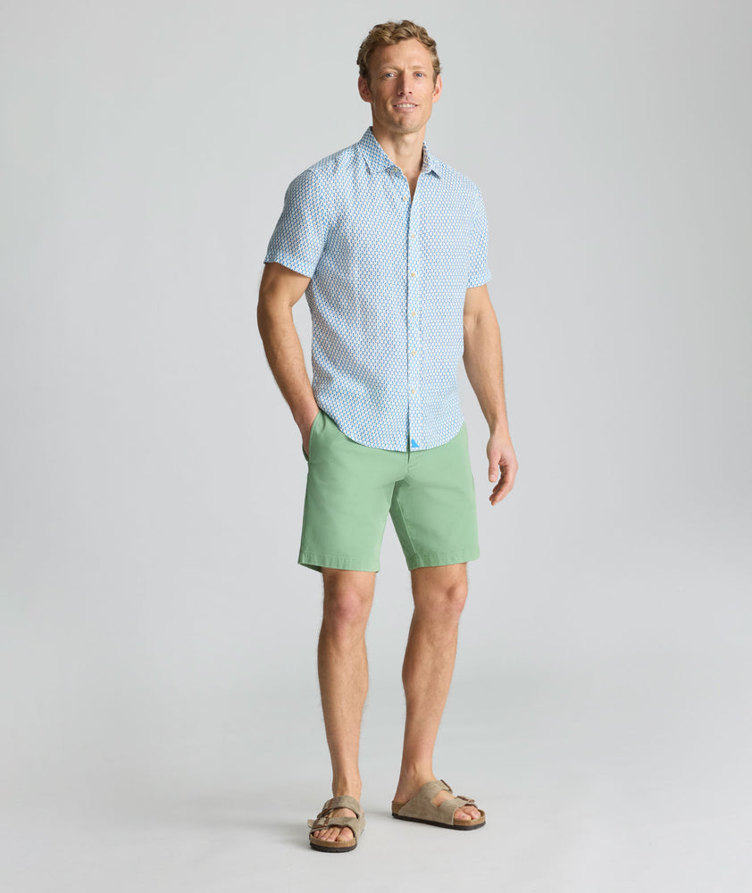 Model is wearing UNTUCKit 9" Stretch Chino Shorts in green. 