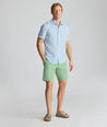 Model is wearing UNTUCKit 9" Stretch Chino Shorts in green. 