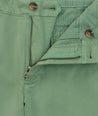 Model is wearing UNTUCKit 9" Stretch Chino Shorts in green. 