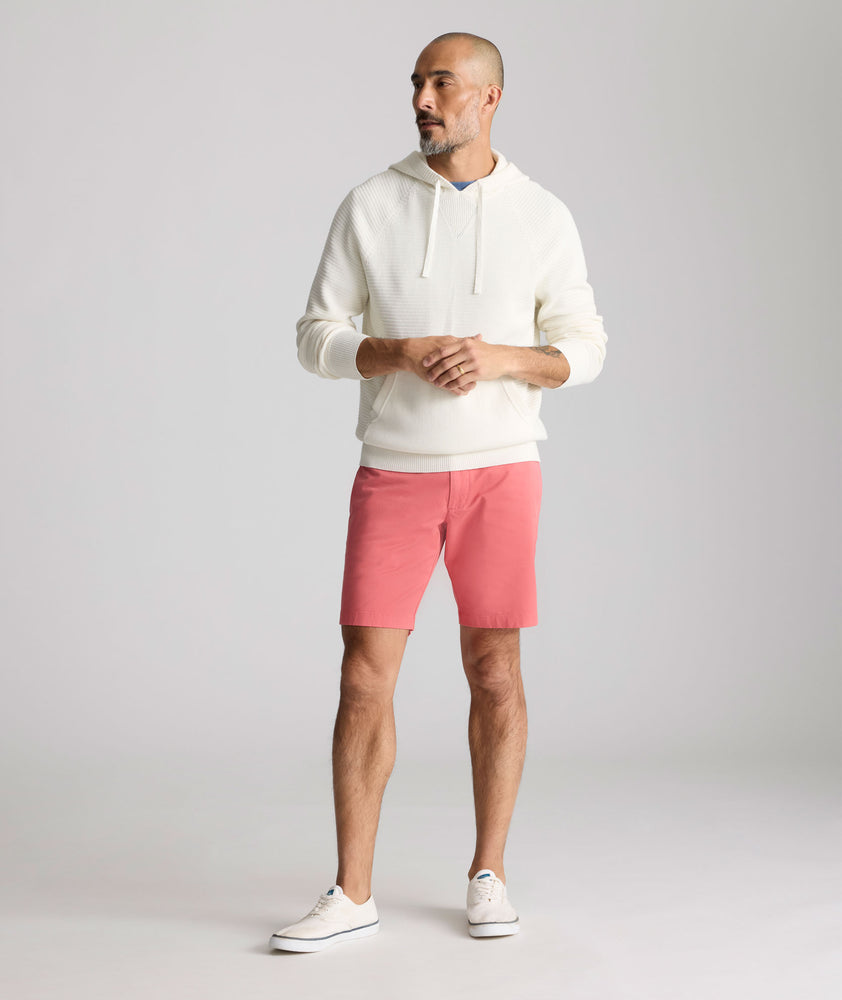 Model is wearing UNTUCKit 9" Stretch Chino Shorts in red. 