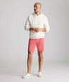 Model is wearing UNTUCKit 9" Stretch Chino Shorts in red. 