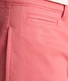 Model is wearing UNTUCKit 9" Stretch Chino Shorts in red. 