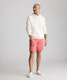 Model is wearing UNTUCKit 9" Stretch Chino Shorts in red. 