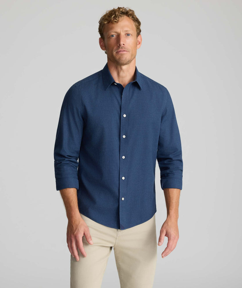 Model is wearing UNTUCKit Wrinkle-Free Gallis Shirt in navy. 
