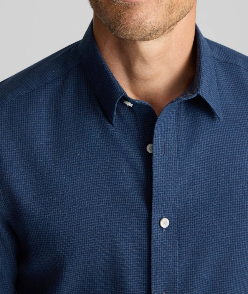 Model is wearing UNTUCKit Wrinkle-Free Gallis Shirt in navy. 