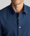 Model is wearing UNTUCKit Wrinkle-Free Gallis Shirt in navy. 