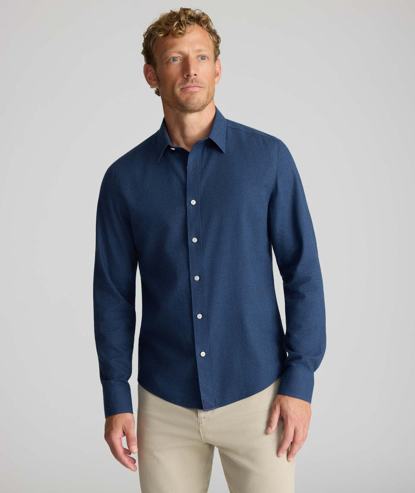 Model is wearing UNTUCKit Wrinkle-Free Gallis Shirt in navy. 