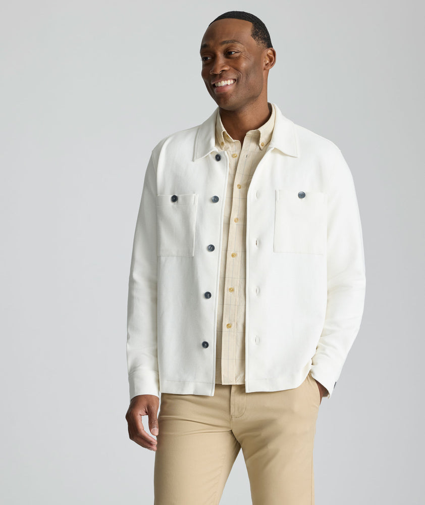 Model is wearing UNTUCKit Knit Overshirt in white. 