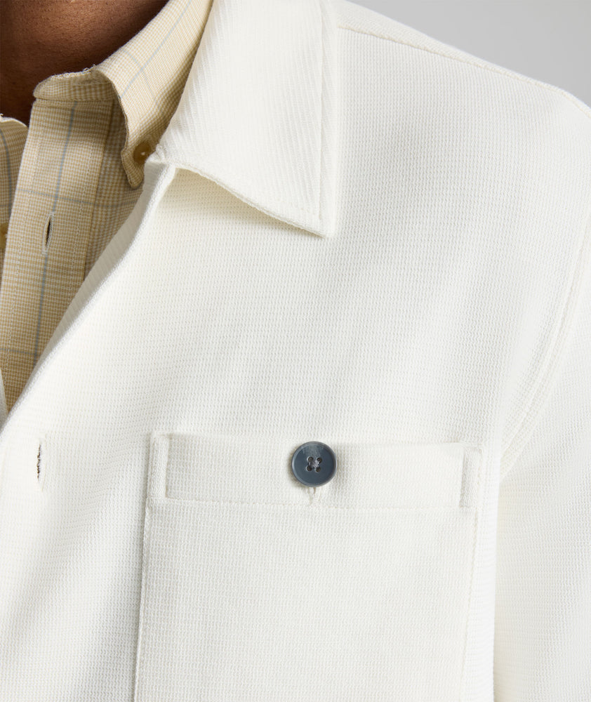 Model is wearing UNTUCKit Knit Overshirt in white. 
