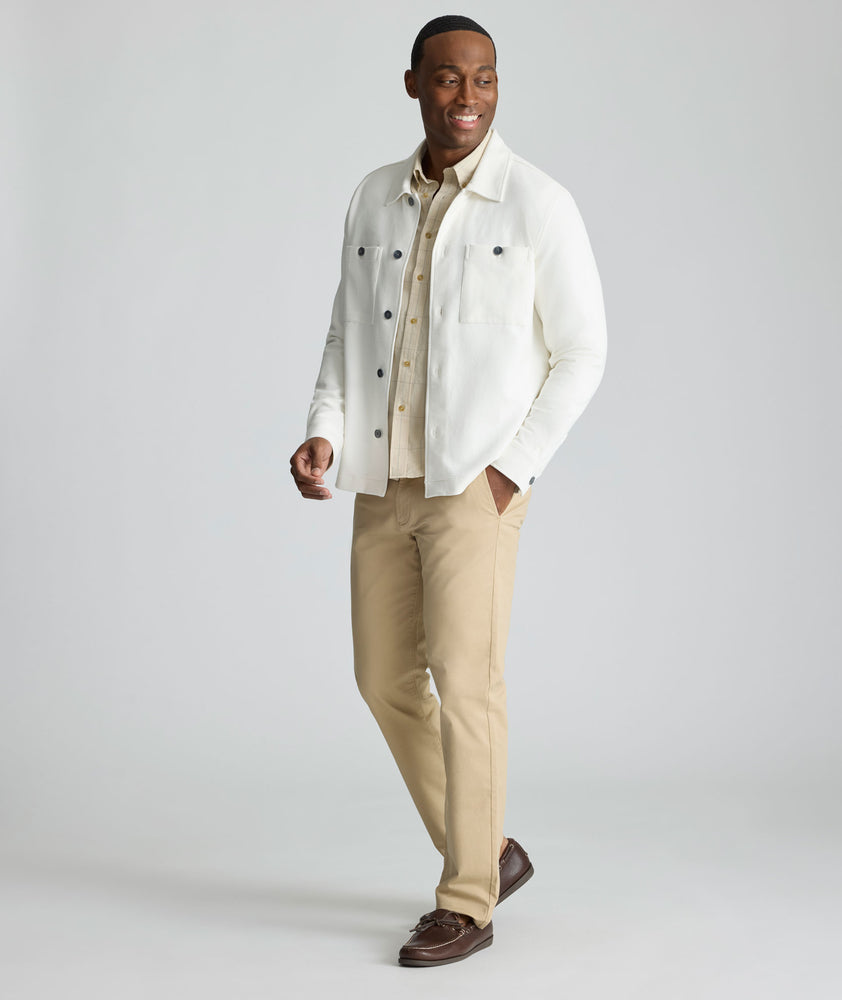 Model is wearing UNTUCKit Knit Overshirt in white. 