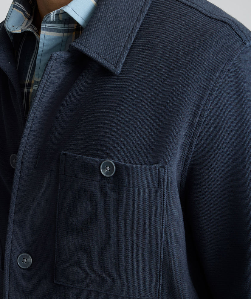 Model is wearing UNTUCKit Knit Overshirt in blue.