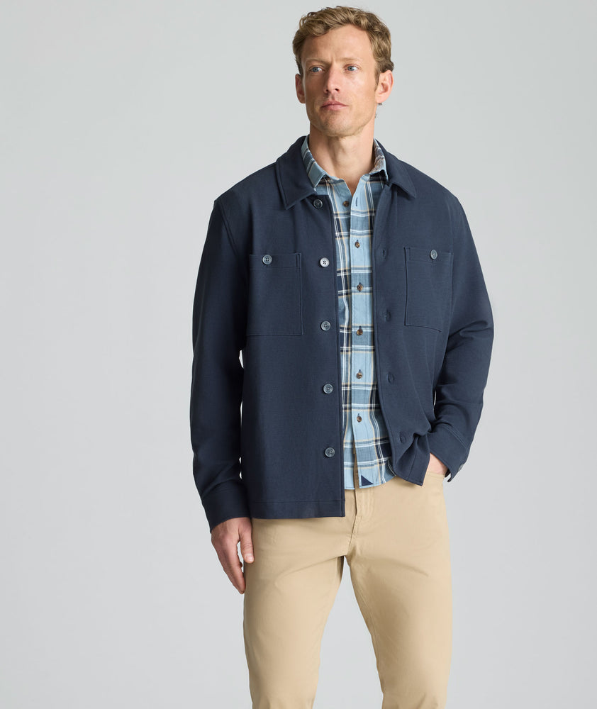 Model is wearing UNTUCKit Knit Overshirt in blue.