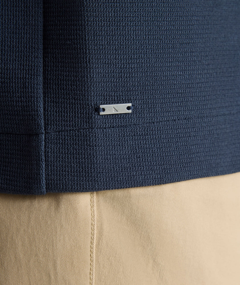 Model is wearing UNTUCKit Knit Overshirt in blue.