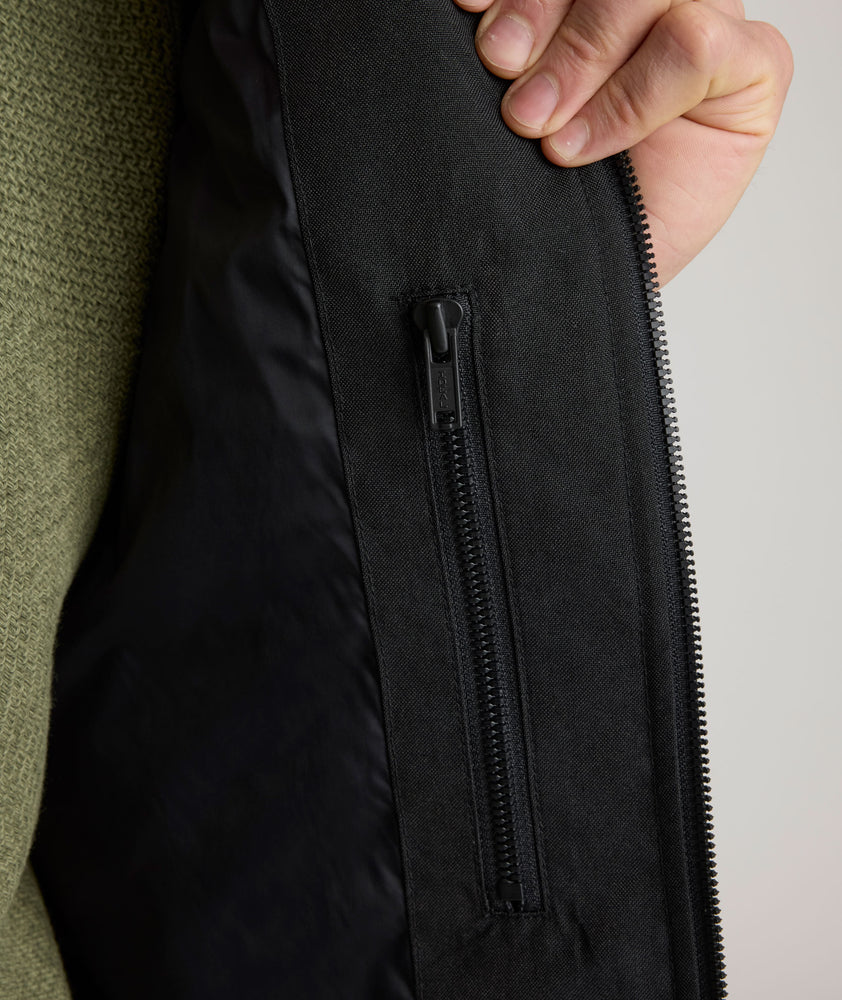 Model is wearing UNTUCKit Gardner jacket in black beauty. 