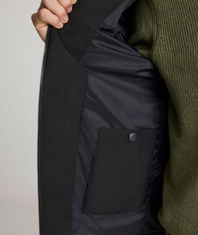 Model is wearing UNTUCKit Gardner jacket in black beauty. 