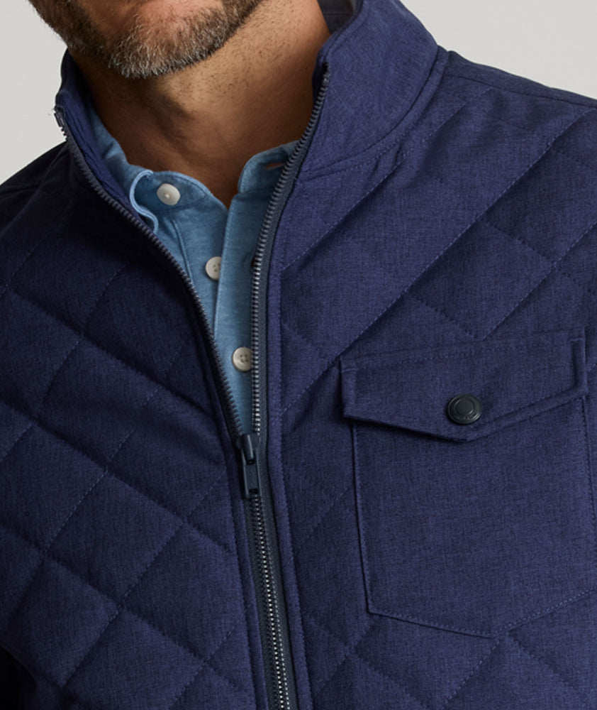 Model is wearing UNTUCKit Gardner quilted jacket in patriot blue.
