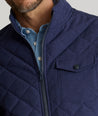 Model is wearing UNTUCKit Gardner quilted jacket in patriot blue.
