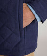 Model is wearing UNTUCKit Gardner quilted jacket in patriot blue.
