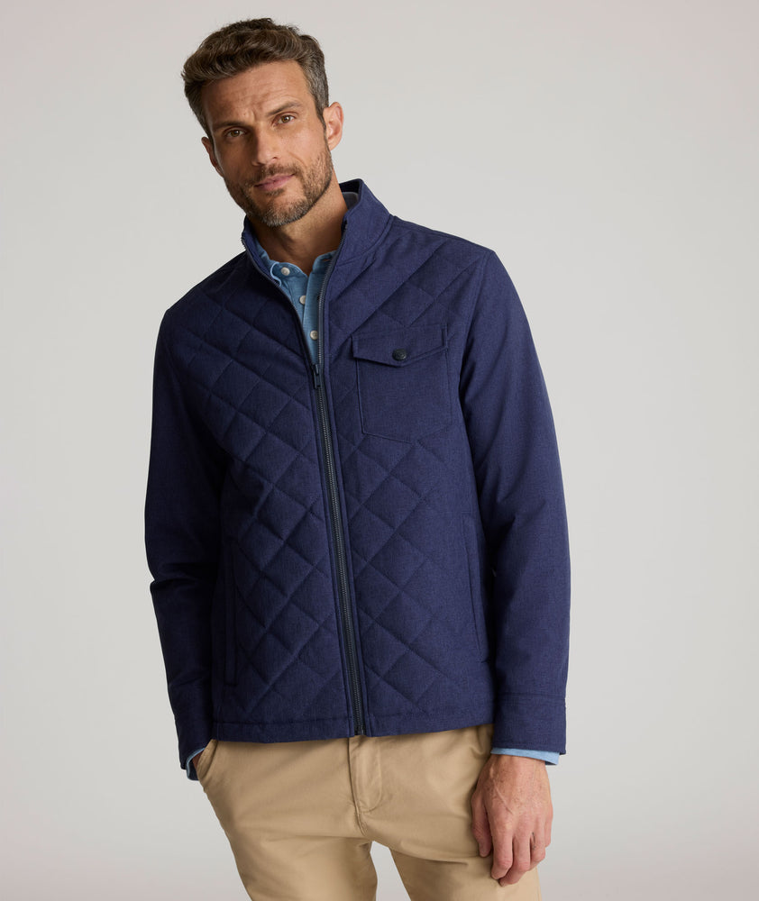 Model is wearing UNTUCKit Gardner quilted jacket in patriot blue.