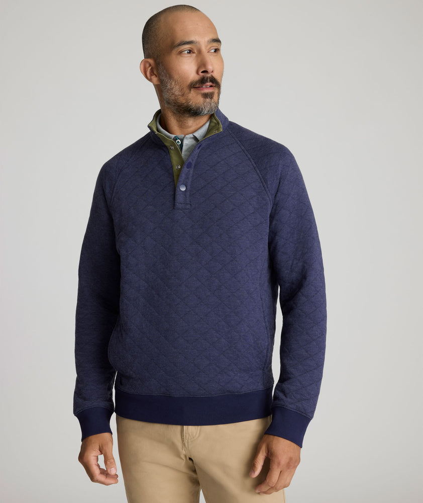 Model is wearing UNTUCKit Garrison pullover in blue. 