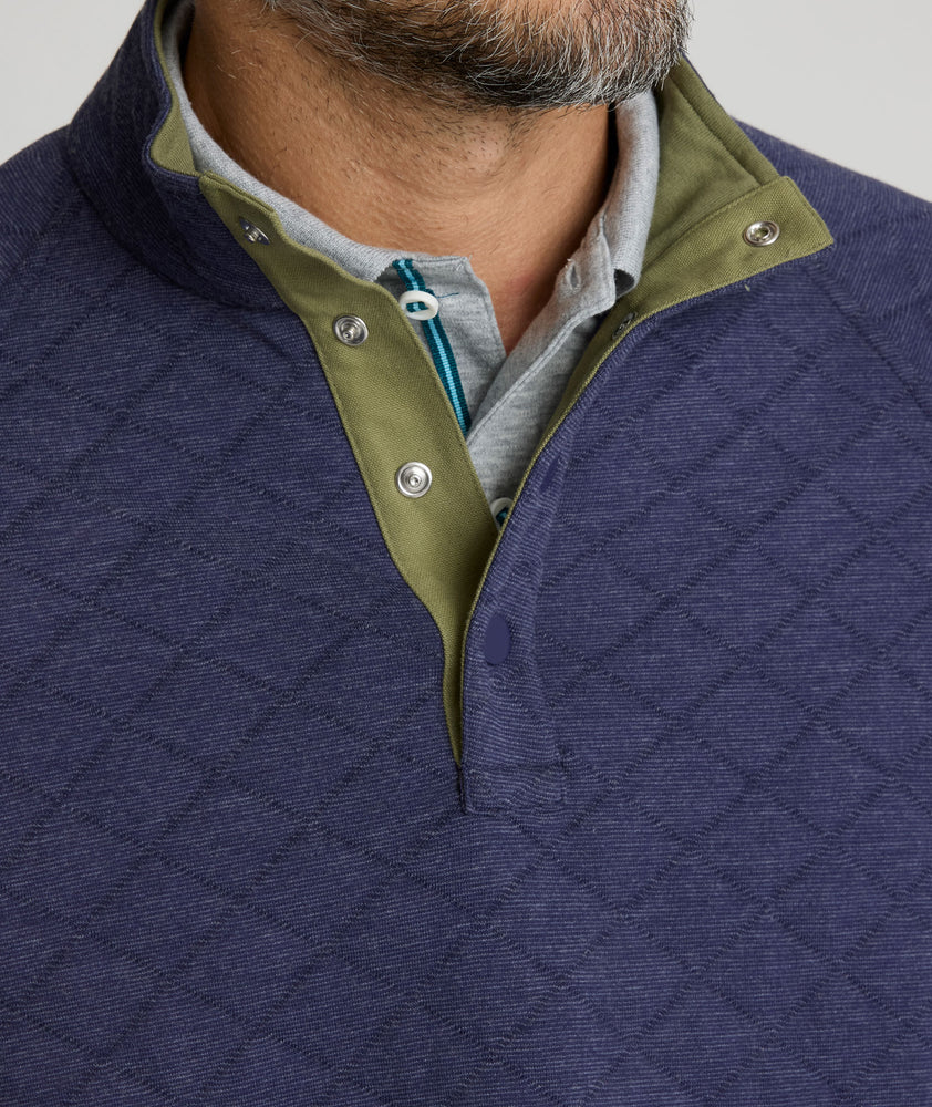 Model is wearing UNTUCKit Garrison pullover in blue. 