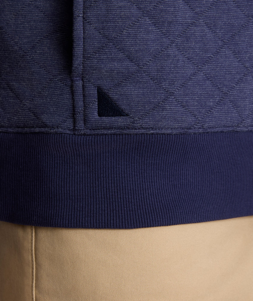 Model is wearing UNTUCKit Garrison pullover in blue. 