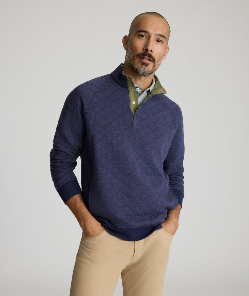 Model is wearing UNTUCKit Garrison pullover in blue. 